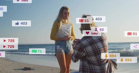 Man proposing on beach with rising social media notifications and digital engagement icons