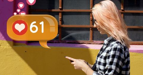 Woman Engaged with Social Media Notifications on Street