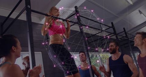Woman Pulling Up on Rig Surrounded by Supportive Team with Digital Network Sphere Overlay