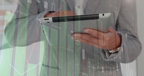 Businessman analyzing financial data with tablet overlay