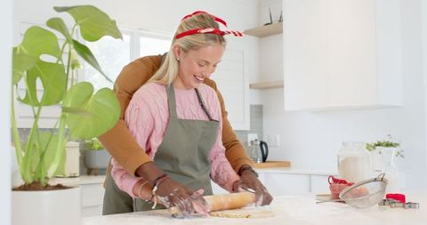 Diverse Couple Rolling Dough Together in Modern Home Kitchen