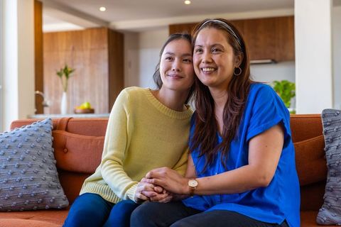 Mother and daughter bonding on cozy sofa in modern living area