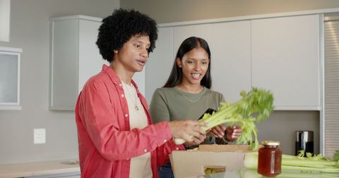 Couple Unpacking Groceries in Modern Kitchen Setting
