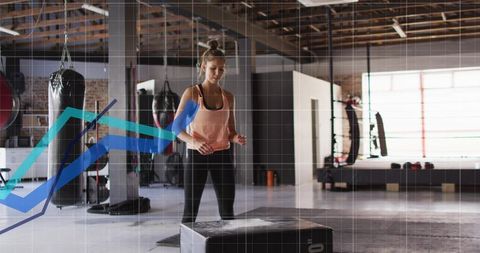 Female Athlete Performing Plyometric Box Jumps in Sunlit Industrial Gym with Punching Bags