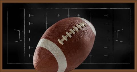 American football with strategy plan in background