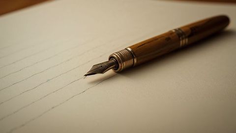Elegant wooden fountain pen on lined paper