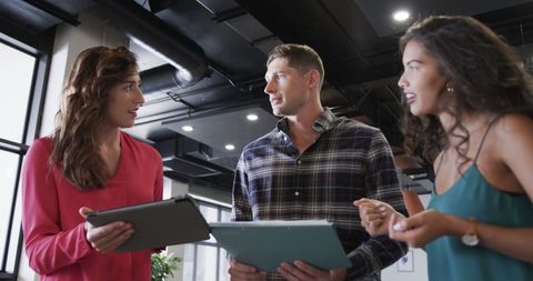 Diverse Team Collaborating and Discussing Project Using Technology