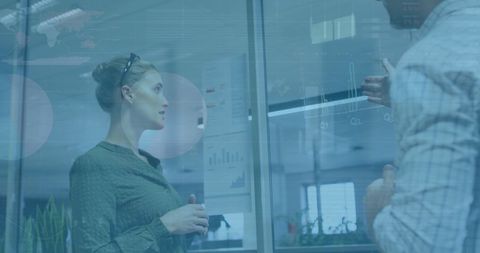 Colleagues Analyzing Financial Data Insights in Modern Office