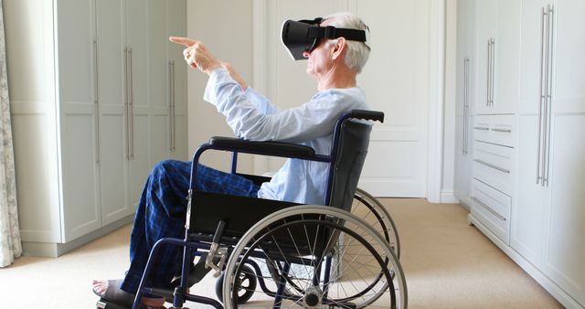 Senior Man Using VR Headset in Wheelchair Pointing at Virtual Object - Download Free Stock Images Pikwizard.com