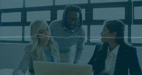 Business team collaborating around laptop with waveform data overlay in modern office