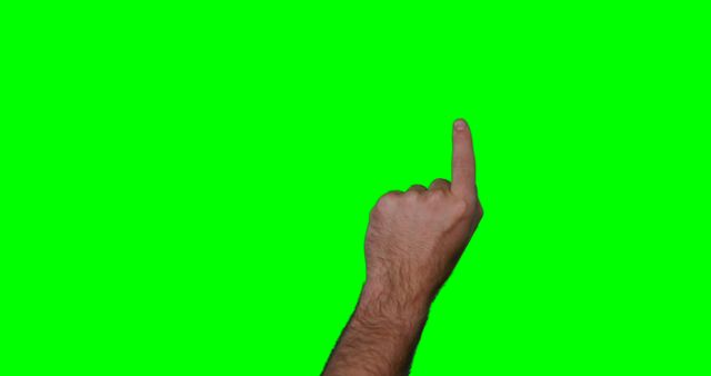 Image of a male hand pointing upward with an extended index finger on a green screen background. Useful for graphic design, instructional materials, signifying a direction or choice, video production, and educational content. Easily adaptable for various uses including overlays, captions, and stimulating interest in presentations.