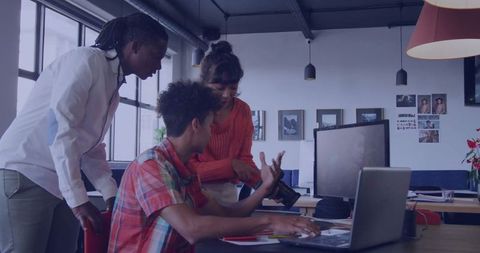Team collaborating over dslr camera in modern office setting