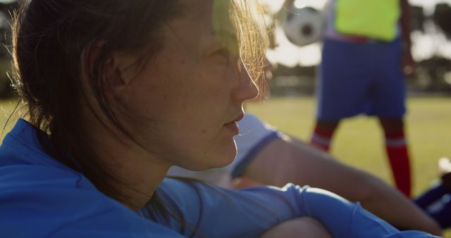 Young Woman Reflecting After Soccer Game on Sunny Day - Download Free Stock Images Pikwizard.com