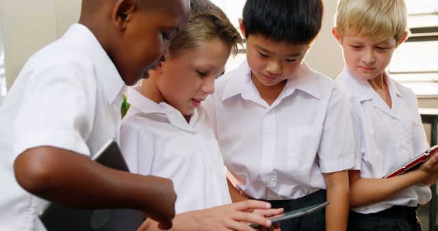 Diverse Group of Schoolboys Using Tablets in Classroom - Download Free Stock Images Pikwizard.com