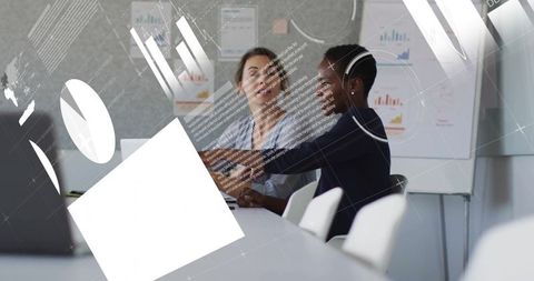 Colleagues discussing work amidst financial data visualizations
