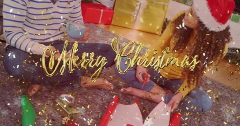 Wrapping christmas gifts together on cozy rug with santa hat and gold confetti