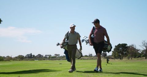 Happy Golfers Walking on Green Course with Bags - Download Free Stock Images Pikwizard.com