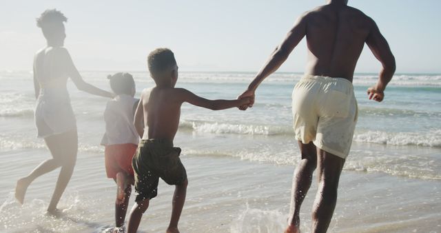 Family Running on Beach near Ocean Surf on Sunny Day - Download Free Stock Images Pikwizard.com