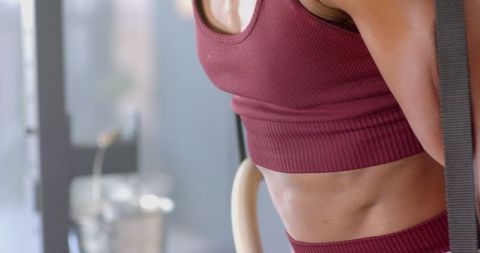 Fit Woman Exercising on Gymnastic Rings at Gym