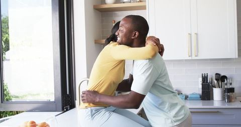 Warm Embrace Between Happy Couple in Sunlit Modern Kitchen - Download Free Stock Images Pikwizard.com