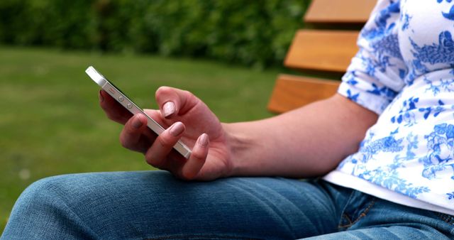 Person Using Smartphone in Outdoor Park Sitting on Bench - Download Free Stock Images Pikwizard.com