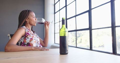 Young Woman Savors Red Wine in Urban Chic Environment - Download Free Stock Images Pikwizard.com
