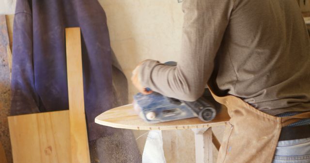 Carpenter Sanding Wood for Surfboard Construction - Download Free Stock Images Pikwizard.com