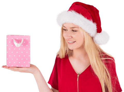 Smiling woman in santa hat holding transparent gift bag