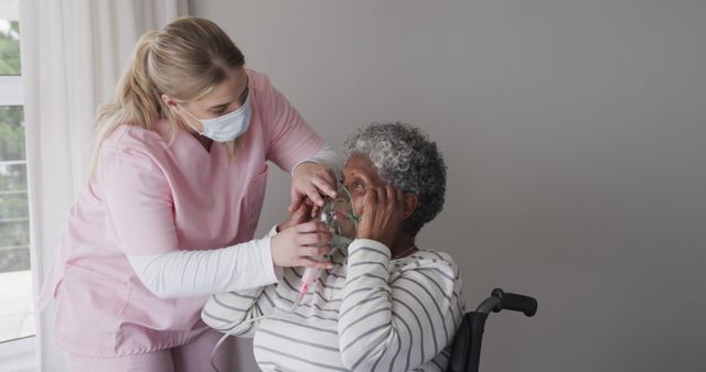 Nurse Assisting Elderly Woman with Oxygen Mask in Healthcare Facility - Download Free Stock Images Pikwizard.com