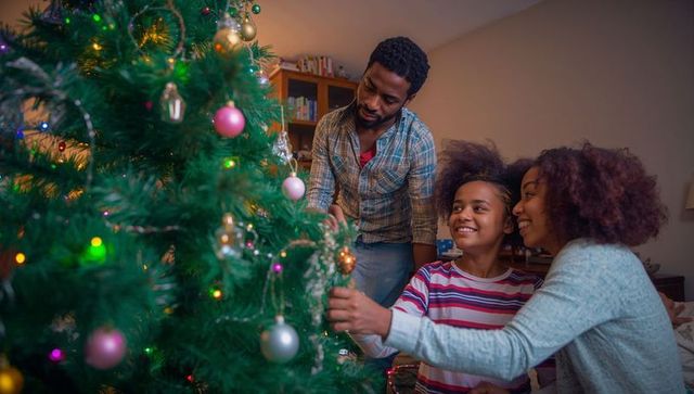Family Bonding While Decorating Christmas Tree at Home