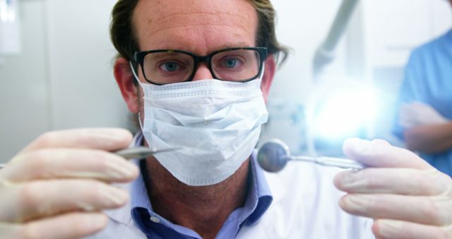 Dentist Wearing Protective Mask Examining Patient with Dental Instruments - Download Free Stock Images Pikwizard.com