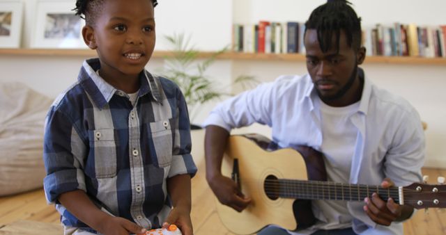 Father and Son Playing Guitar and Video Games at Home - Download Free Stock Images Pikwizard.com