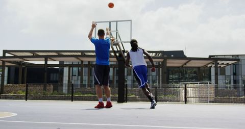 Basketball Players Practicing Shots on Outdoor Court