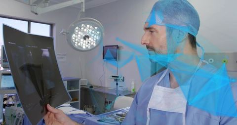 Surgeon examining x-ray in operating room with surgical lamp and instrument tray