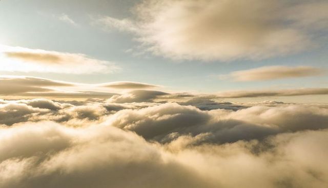 Golden Cloudscape Spilling Across High-Altitude Layered Sky at Sunrise