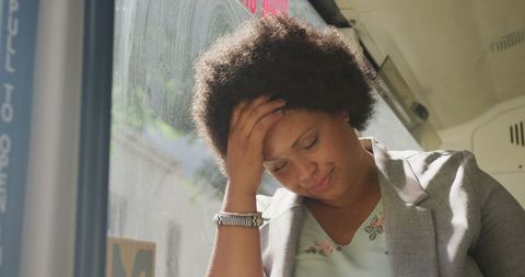 Pensive plus size woman reflecting on bus commute