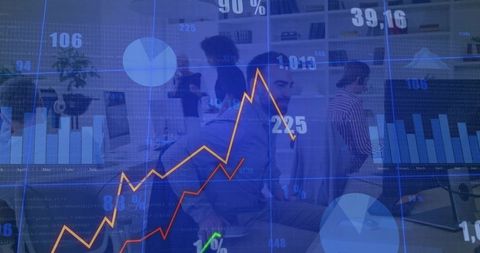 Reviewing business team collaborating over analytics dashboards in modern open-plan office