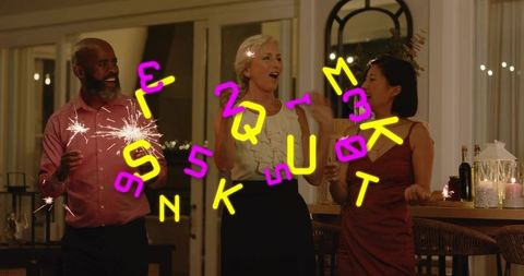 Diverse friends celebrating with sparklers and candles at home for cozy festive gathering