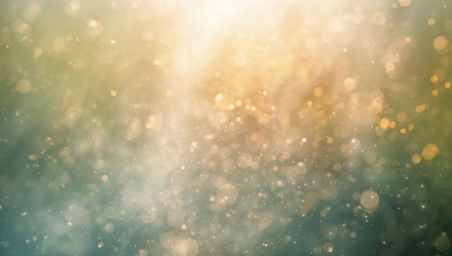Shimmering golden-teal bokeh background with sparkling dust motes and soft sunlight