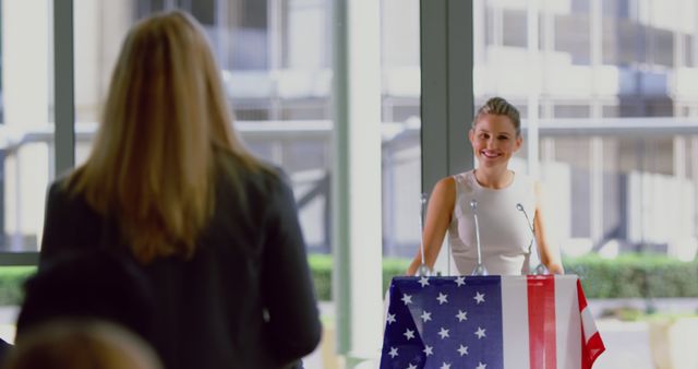 Female Politician Delivering Speech to Audience with American Flag - Download Free Stock Images Pikwizard.com