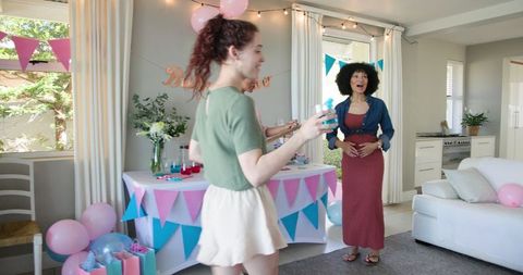 Multiracial Friends Celebrating Baby Shower with Festive Decorations