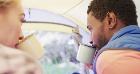 Diverse Couple Enjoying Tent Outing with Tea