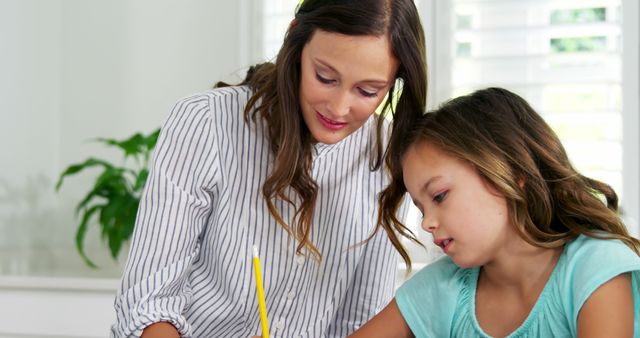 Teacher Helping Elementary Student with Homework at Desk - Download Free Stock Images Pikwizard.com