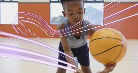 Energetic Boy Practicing Basketball Dribbling on Indoor Court