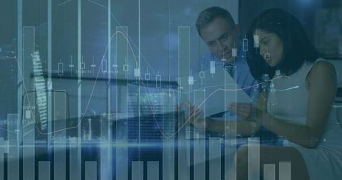 Business partners analyzing financial charts and documents for corporate strategy and investments