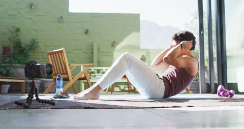 Man Doing Crunches at Home Recording Fitness Vlog