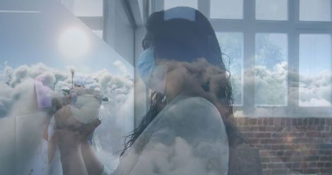 Woman in Mask Writing in Office with Dreamy Sky Reflection