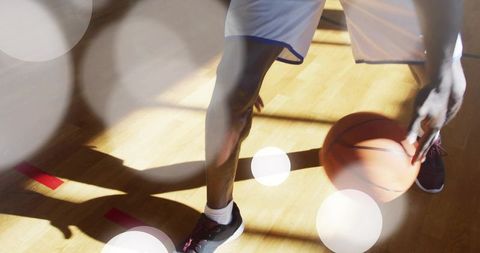 Athlete Dribbling Basketball on Hardwood Court