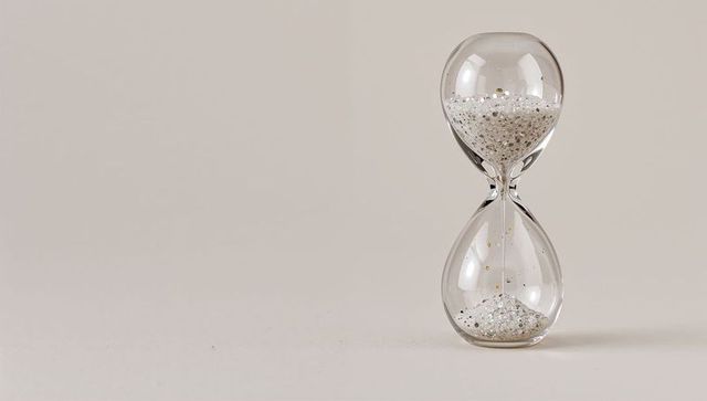 Elegant Hourglass with White Granules on Clear Surface