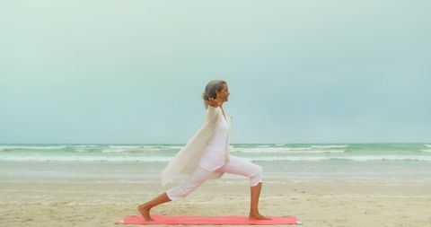 Senior Woman Practicing Yoga Pose on Tranquil Beach - Download Free Stock Images Pikwizard.com